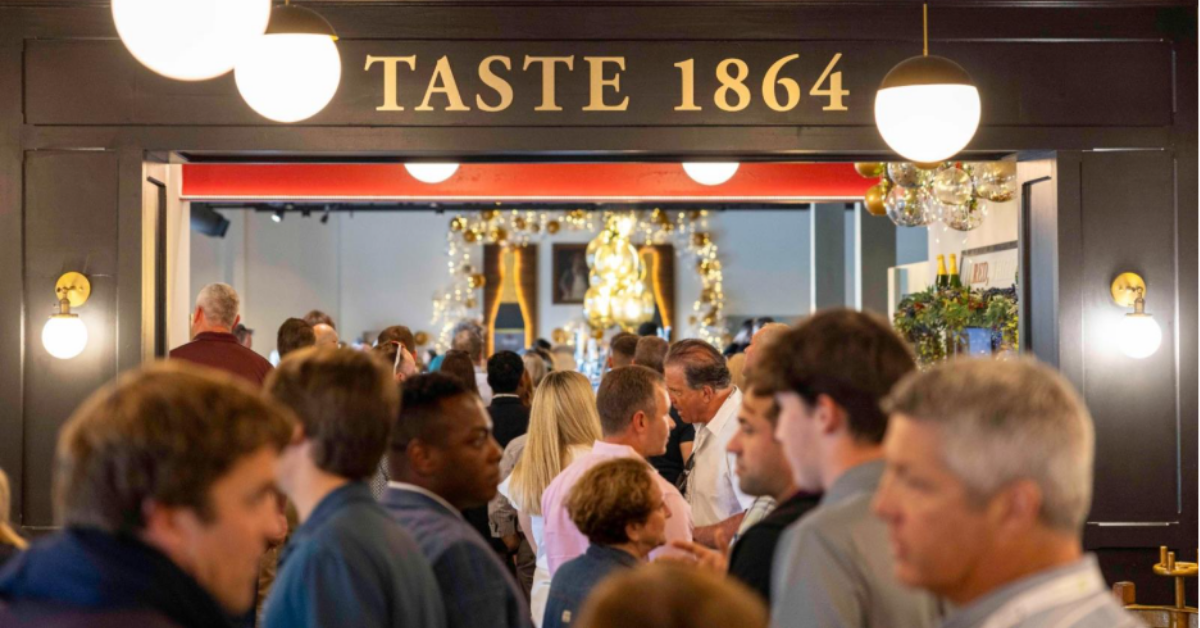Guests entering Taste 1864, the signature restaurant at Renault Winery Resort in New Jersey, during an investor event hosted by Accountable Equity — a destination hospitality real estate syndication firm that owns the property, with resort operations managed by Vivamee Hospitality under shared leadership.