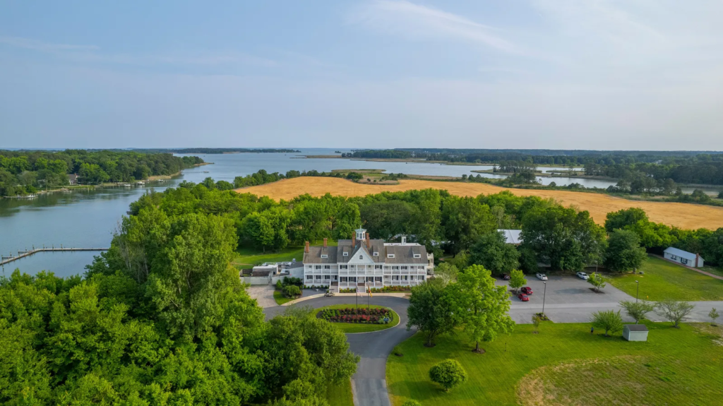 Aerial view of Kent Island Resort showing the Manor House surrounded by nearly two miles of waterfront on Thompson Creek in Maryland. The property is owned by the funds offered by Accountable Equity and operated by Vivamee Hospitality.
