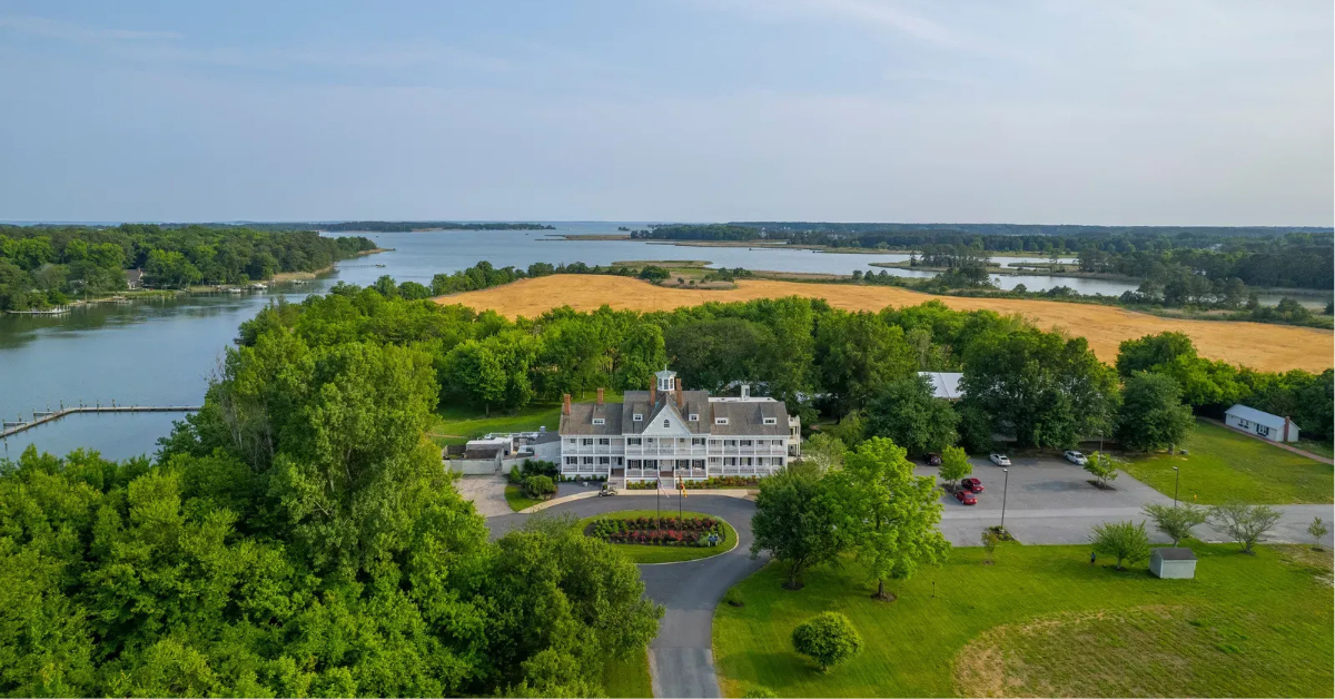 kent-island-resort-manor-house-waterfront-aerial Aerial view of Kent Island Resort Manor House in Stevensville, MD, with nearly two miles of waterfront on Thompson Creek visible, owned by the funds offered by Accountable Equity and operated by Vivamee Hospitality