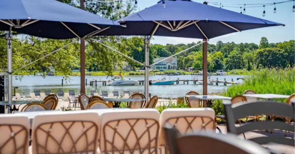 kent-island-resort-waterfront-event.jpg Waterfront patio dining at Kent Island Resort in Stevensville, Maryland, overlooking Thompson Creek, operated by Vivamee Hospitality