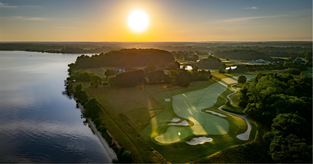 golf-course-real-estate-investment-queenstown-harbor-aerial.jpg Aerial sunrise view of Queenstown Harbor Golf Resort showing a championship fairway along the Chester River in Queenstown, Maryland, illustrating the scale of golf course real estate investment