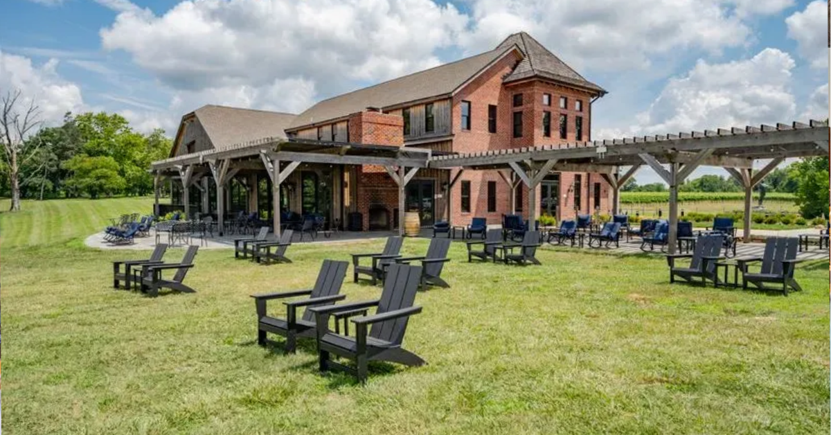 The Vineyard House at Bohemia Manor Farm featuring outdoor seating, covered pergola, and vineyard views in Chesapeake City, Maryland